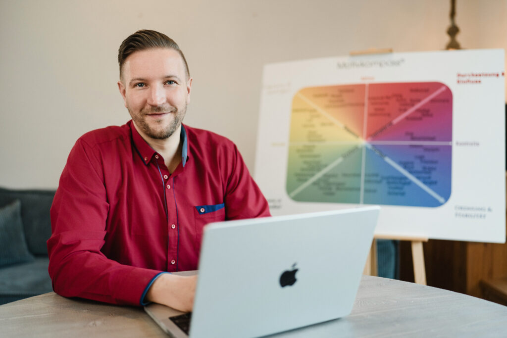 Bindungs- und Emotionscoach Benjamin Schwend sitzend vor Motivkompass
